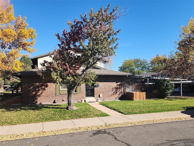 obstructed view of property with a front lawn