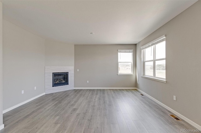 unfurnished living room with light hardwood / wood-style flooring