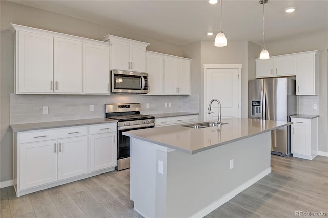 kitchen with white cabinetry, pendant lighting, and appliances with stainless steel finishes