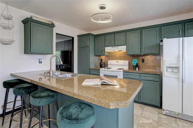 kitchen featuring kitchen peninsula, green cabinets, decorative light fixtures, sink, and white appliances