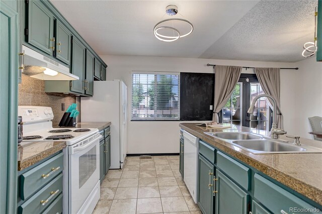 kitchen with white appliances, a textured ceiling, tasteful backsplash, sink, and green cabinetry