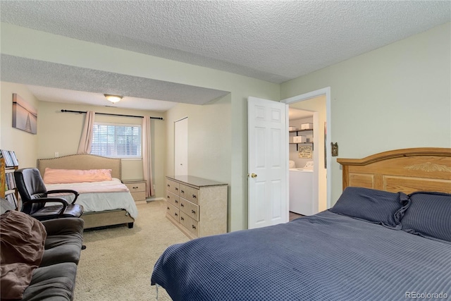 bedroom featuring light colored carpet and a textured ceiling