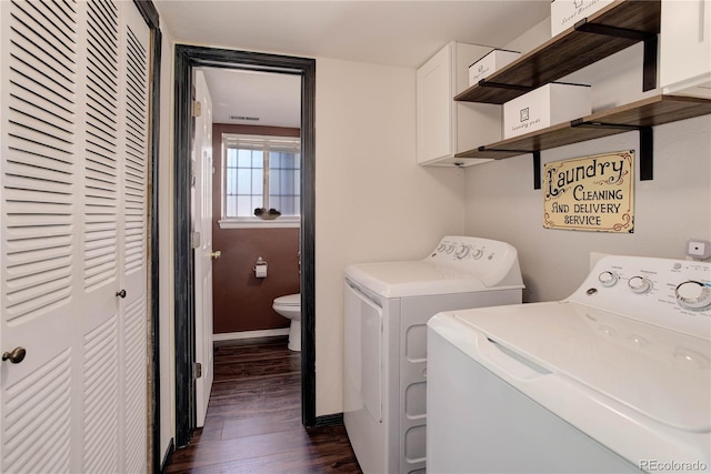 laundry room featuring cabinets, dark hardwood / wood-style floors, and independent washer and dryer