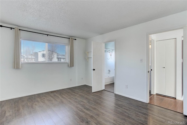 interior space featuring a textured ceiling and dark hardwood / wood-style flooring