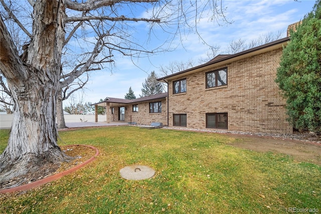 rear view of property featuring a yard