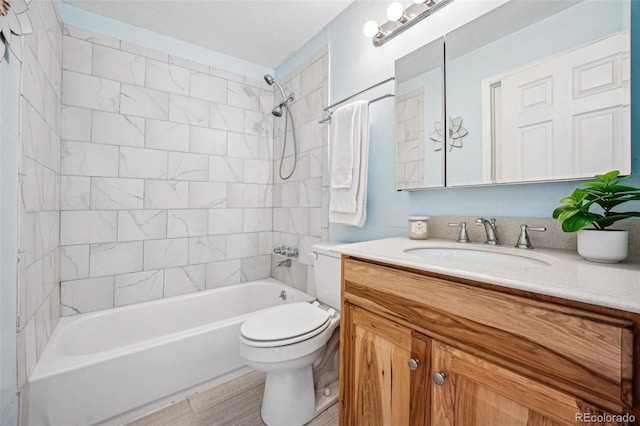 full bathroom with vanity, toilet, and tiled shower / bath combo