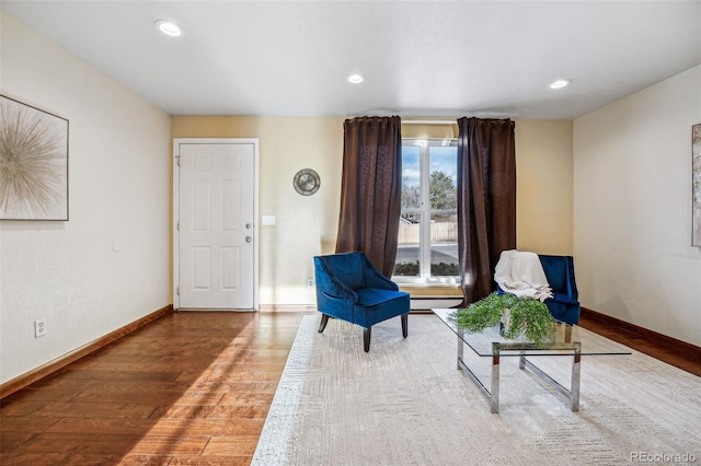 living area featuring hardwood / wood-style floors and a baseboard radiator