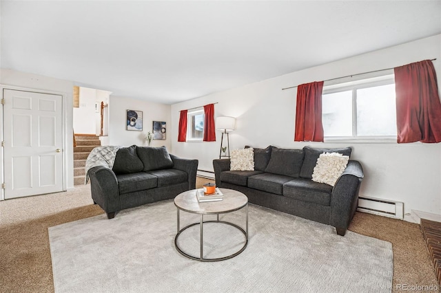 living room with a baseboard heating unit, a wealth of natural light, and carpet flooring