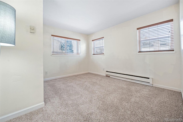 spare room with a baseboard radiator and light colored carpet