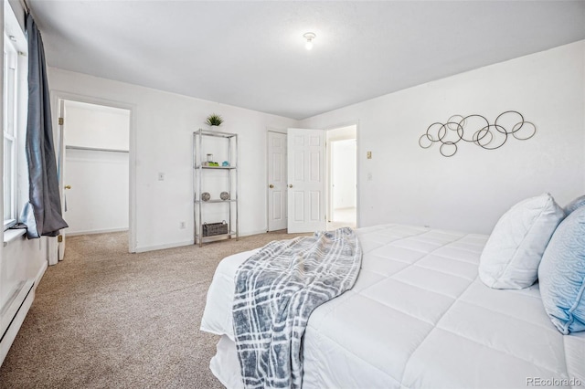 carpeted bedroom with baseboard heating