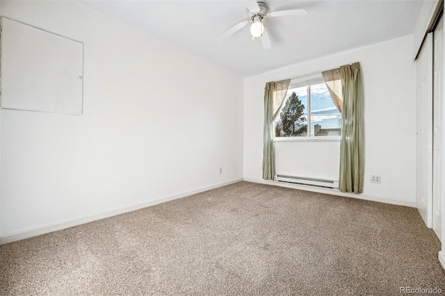 carpeted empty room featuring ceiling fan and a baseboard heating unit