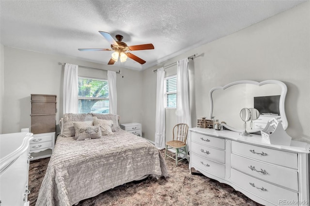 313 E Grant Ave, Fowler, CO 81039 - bedroom with a textured ceiling, carpet, and ceiling fan