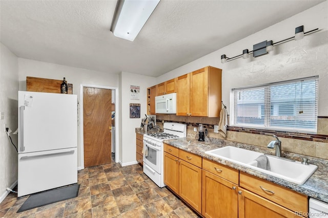 313 E Grant Ave, Fowler, CO 81039 - kitchen with white appliances, a sink, baseboards, a textured ceiling, and stone finish flooring