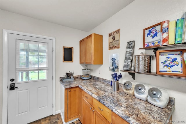 313 E Grant Ave, Fowler, CO 81039 - laundry area featuring baseboards and dark stone finish flooring