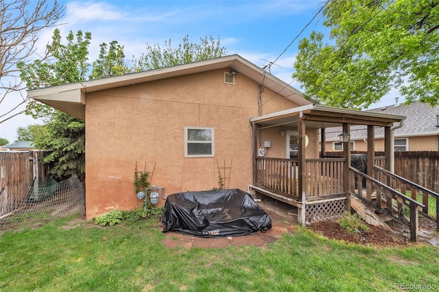 313 E Grant Ave, Fowler, CO 81039 - rear view of property with stucco siding and a deck