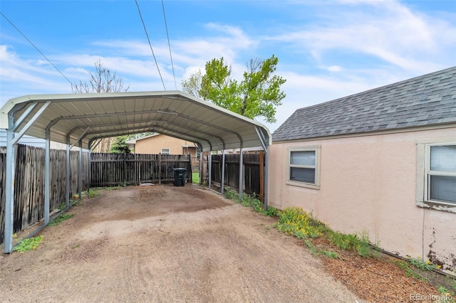 313 E Grant Ave, Fowler, CO 81039 - view of parking / parking lot with fence and a detached carport