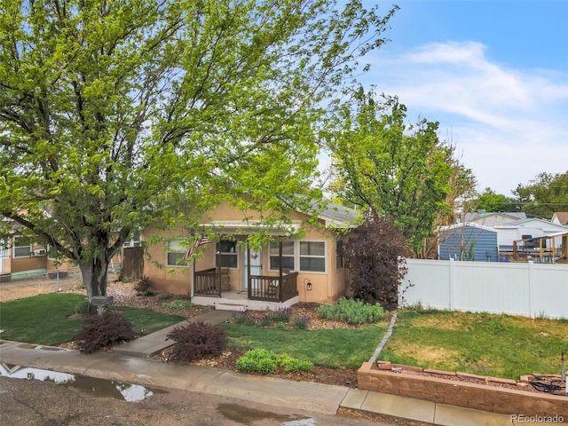313 E Grant Ave, Fowler, CO 81039 - obstructed view of property featuring stucco siding and a porch