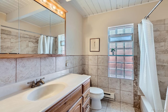 full bath featuring tile patterned flooring, toilet, vanity, tile walls, and baseboard heating