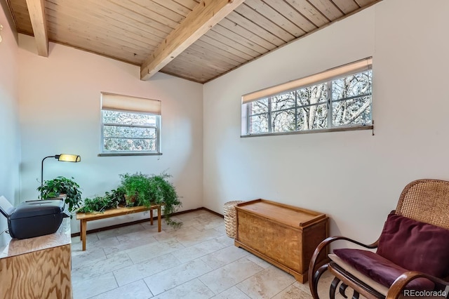 living area featuring vaulted ceiling with beams, wooden ceiling, and baseboards