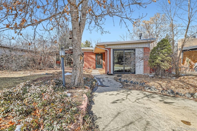 mid-century modern home with brick siding