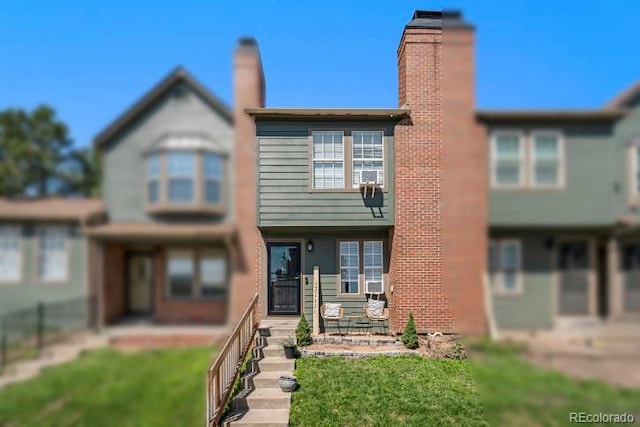 view of property featuring a front lawn