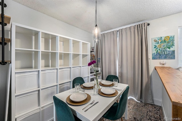 dining room featuring a textured ceiling