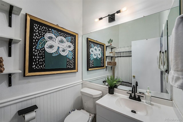 bathroom featuring vanity and toilet