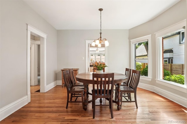 2360 S Milwaukee St, Denver, CO 80210 - dining space with a chandelier and light wood finished floors