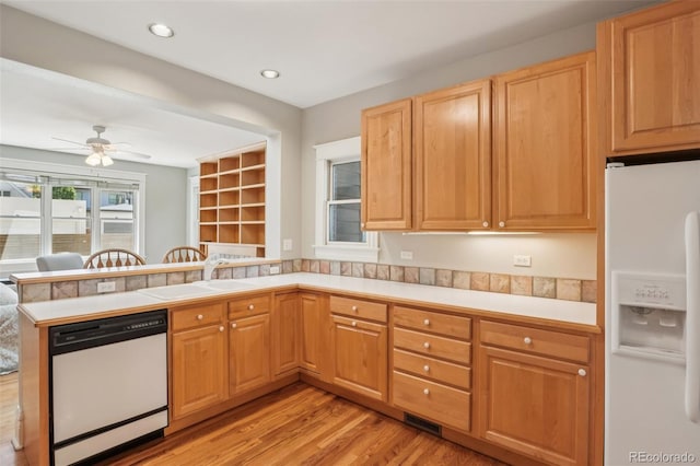 2360 S Milwaukee St, Denver, CO 80210 - kitchen with white appliances, a peninsula, light wood finished floors, light countertops, and a ceiling fan