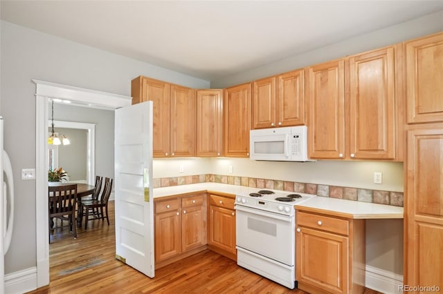 2360 S Milwaukee St, Denver, CO 80210 - kitchen featuring white appliances, light brown cabinets, light wood finished floors, and light countertops