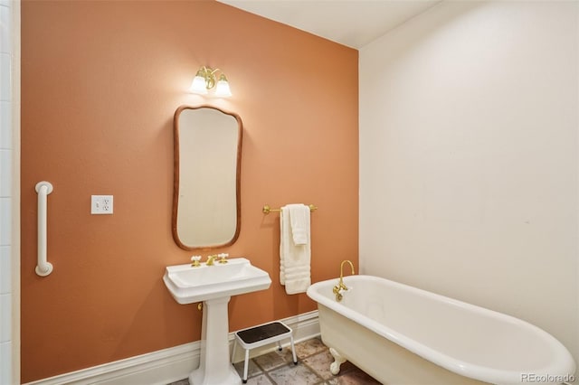 2360 S Milwaukee St, Denver, CO 80210 - full bathroom featuring a freestanding tub and baseboards