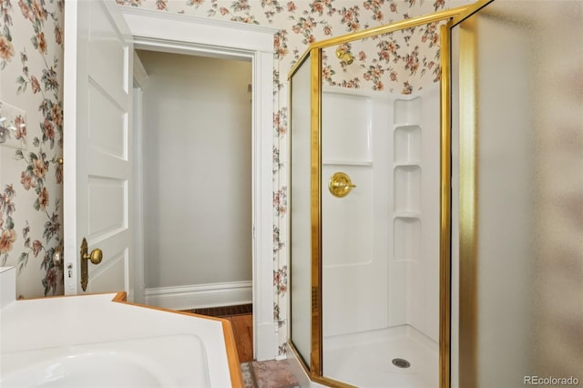 2360 S Milwaukee St, Denver, CO 80210 - bathroom with wallpapered walls, a stall shower, and wood finished floors