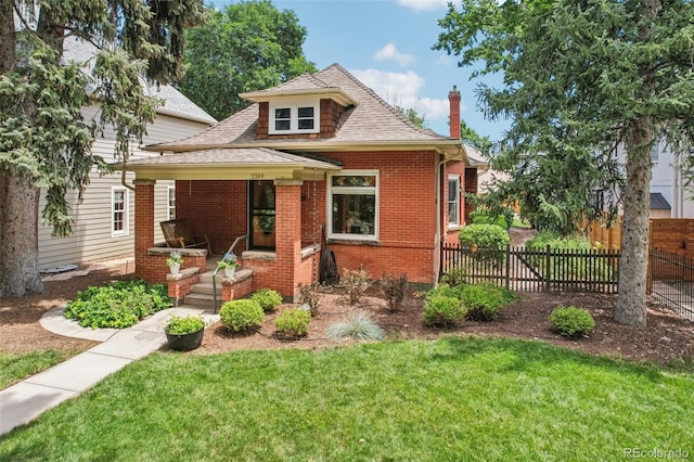2360 S Milwaukee St, Denver, CO 80210 - bungalow-style home featuring roof with shingles, brick siding, a chimney, and covered porch