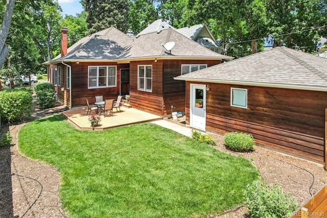 2360 S Milwaukee St, Denver, CO 80210 - back of property featuring a wooden deck, roof with shingles, and a lawn