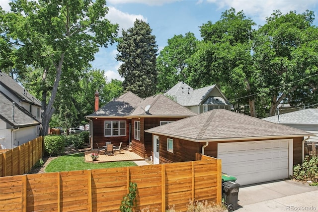 2360 S Milwaukee St, Denver, CO 80210 - view of front facade featuring an attached garage, roof with shingles, a wooden deck, and driveway