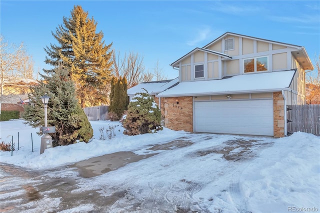 view of snowy exterior with a garage