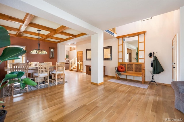 interior space with beamed ceiling, coffered ceiling, and light wood-type flooring