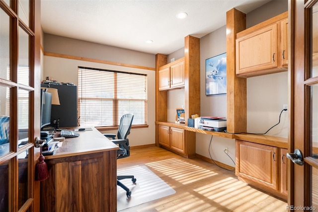 office area with french doors and light hardwood / wood-style flooring