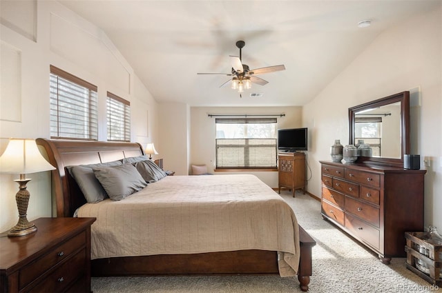 carpeted bedroom featuring ceiling fan and vaulted ceiling