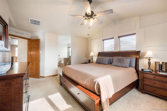 carpeted bedroom featuring ensuite bath, ceiling fan, and vaulted ceiling