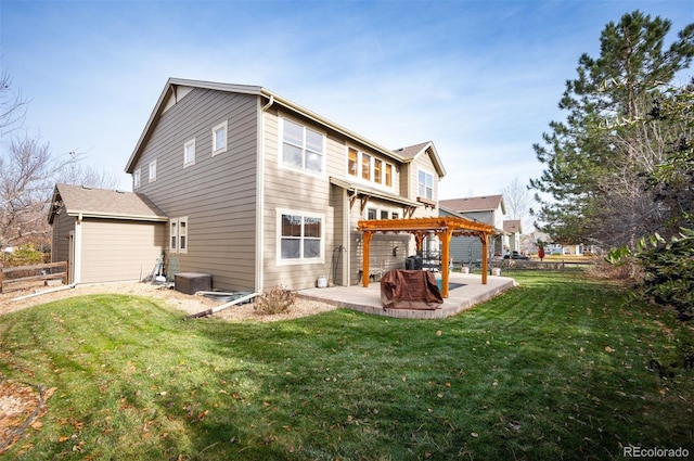 rear view of property featuring a yard, a pergola, and a patio area