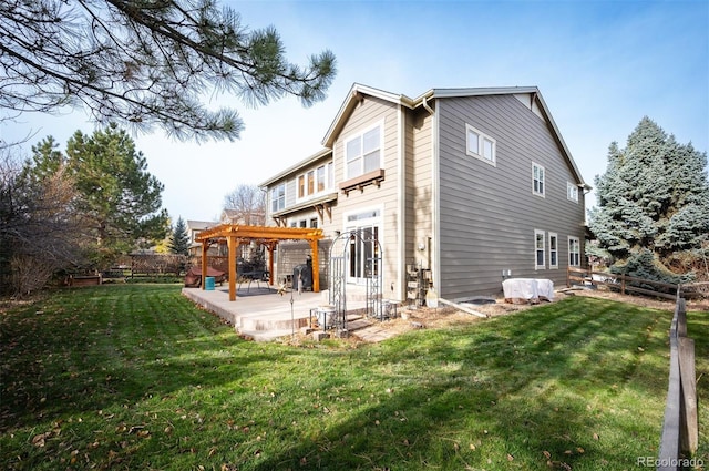 rear view of house with a pergola and a lawn