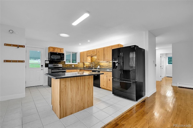 26752 Vosler St, Conifer, CO 80433 - kitchen with black appliances, a center island, baseboards, decorative backsplash, and dark countertops