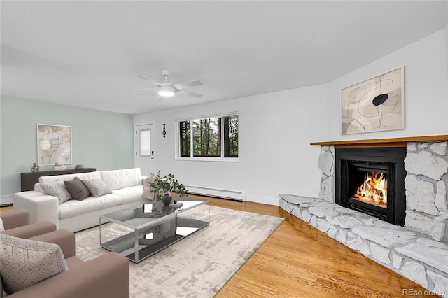 26752 Vosler St, Conifer, CO 80433 - living room featuring a baseboard radiator, a fireplace, wood finished floors, a ceiling fan, and baseboards