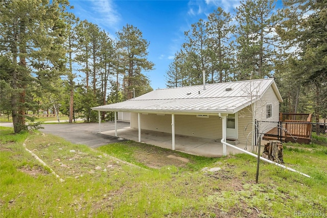 26752 Vosler St, Conifer, CO 80433 - back of property with a standing seam roof, metal roof, and a wooden deck