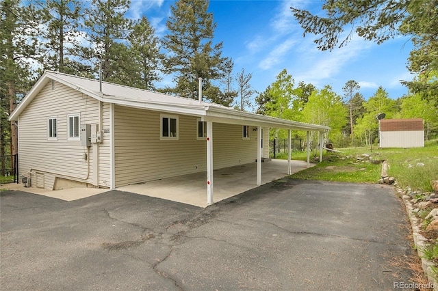 26752 Vosler St, Conifer, CO 80433 - view of property exterior featuring an attached carport and driveway