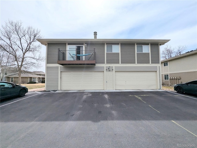 view of property featuring a balcony and a garage