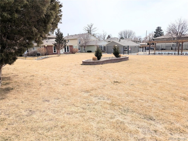 view of yard with a residential view and fence