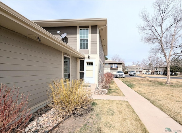 exterior space featuring a yard and a residential view