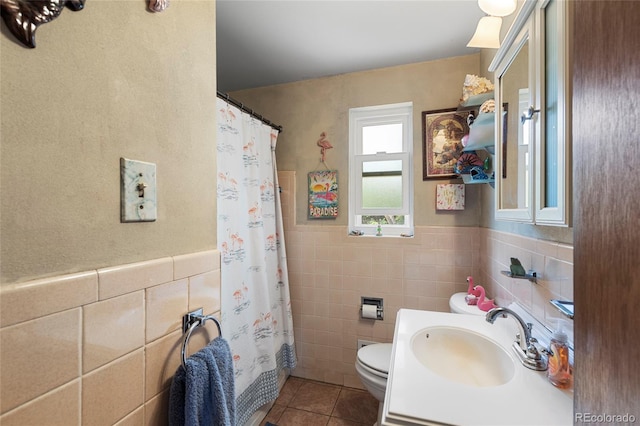 9830 E 5th Ave N, Aurora, CO 80010 - bathroom with tile patterned floors, tile walls, vanity, a wainscoted wall, and a shower with curtain